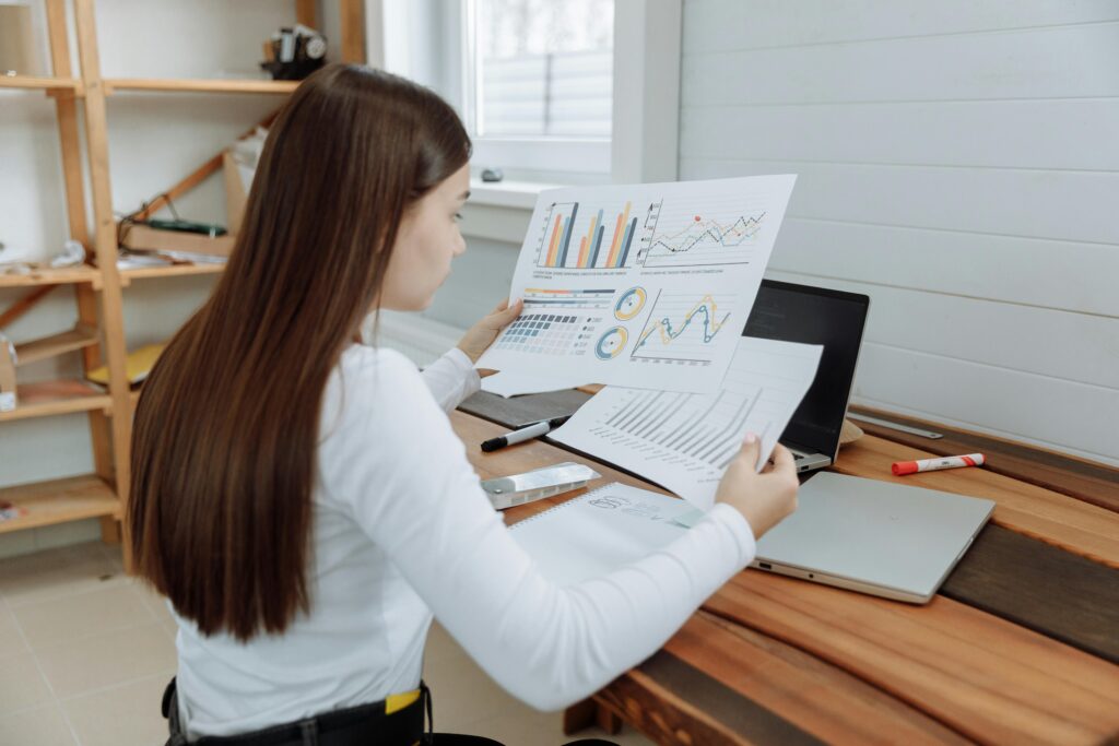 Woman holding charts of a customer acquisition strategy